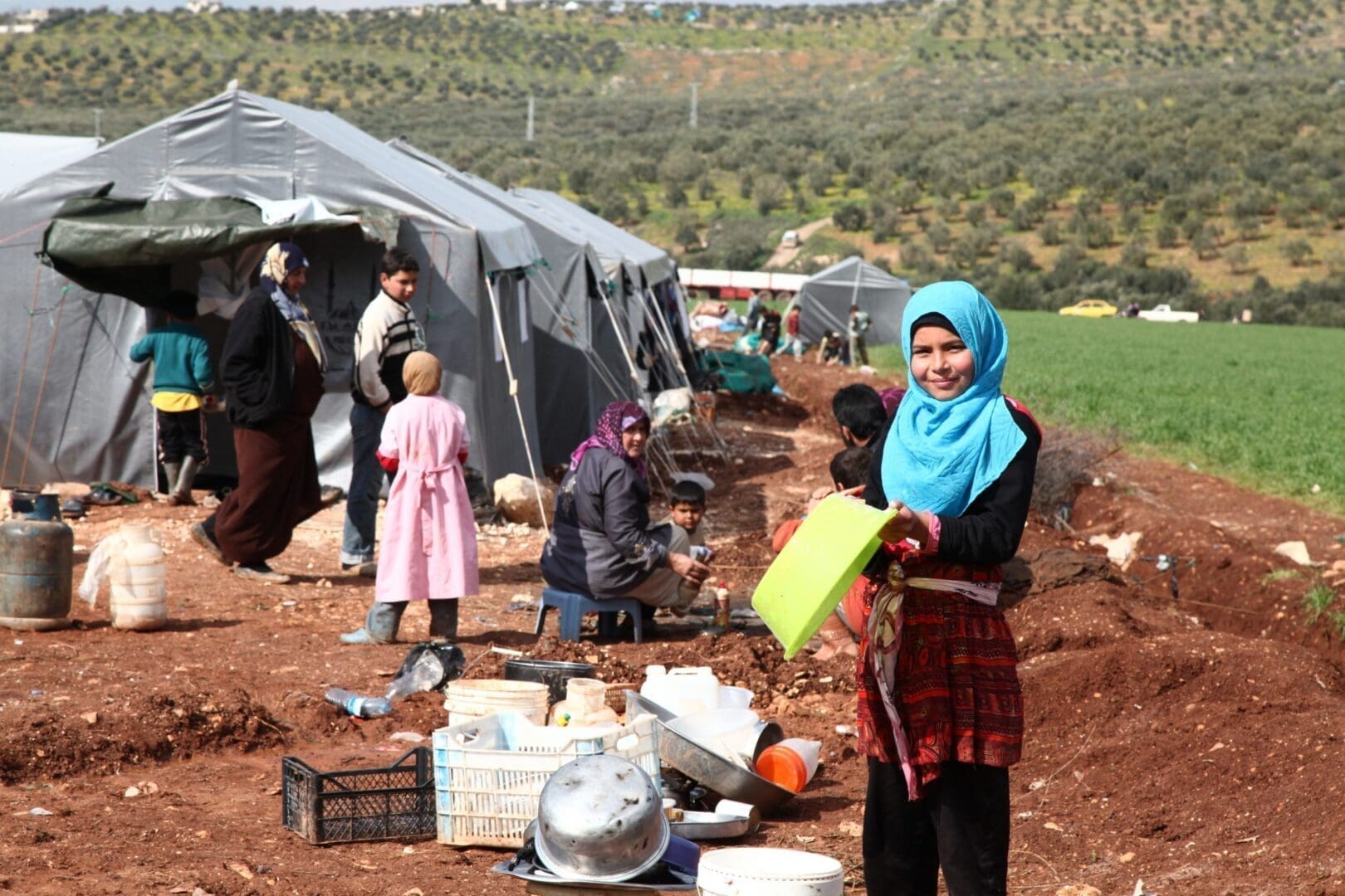 Daughter of Um Suleiman outside their tent in Idleb, Syria